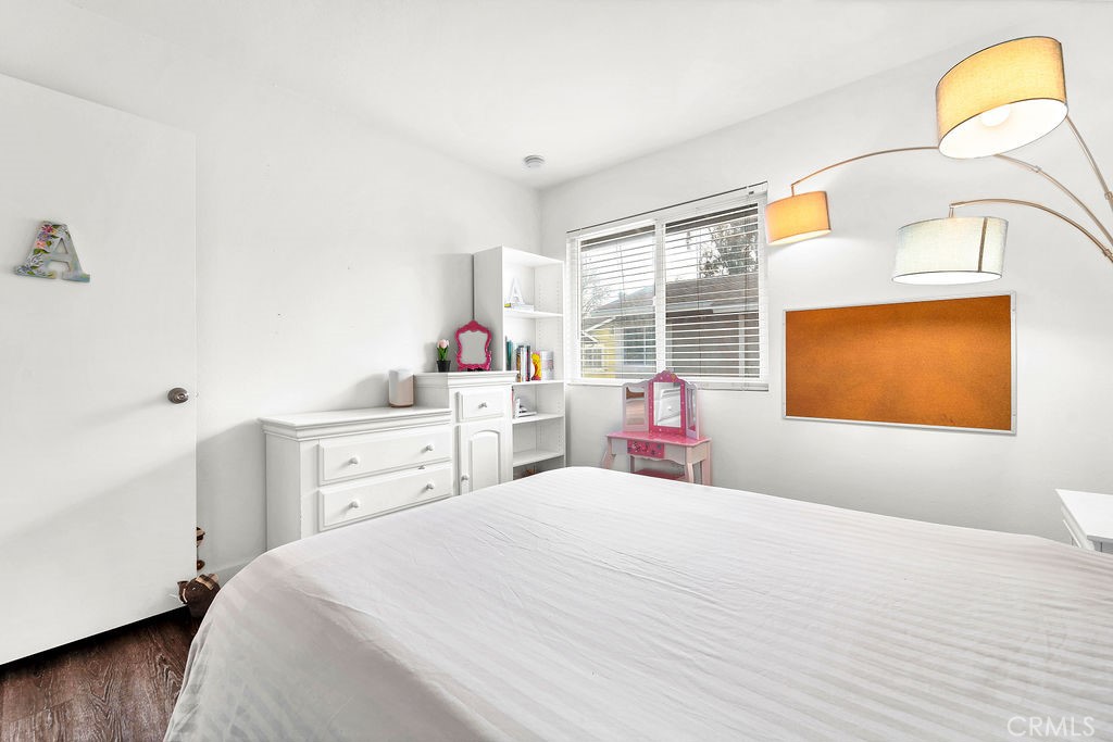 4267 Arcata Bay Way Oceanside, CA 92058 - Photo 18 of 34 a bedroom with a bed and wooden floor