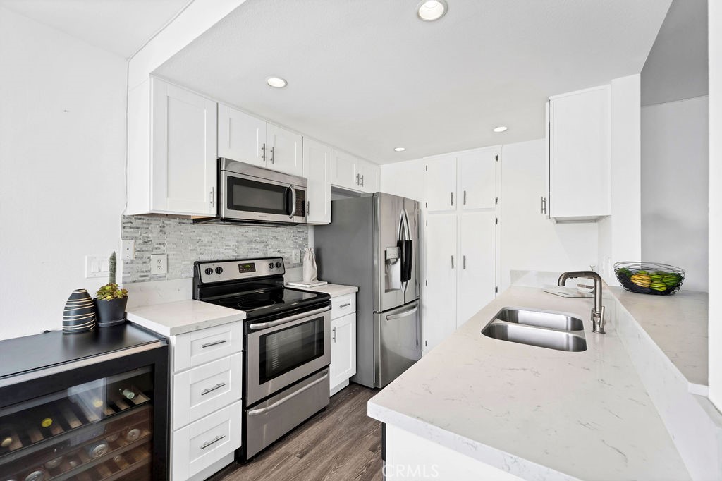 4267 Arcata Bay Way Oceanside, CA 92058 - Photo 24 of 34 a kitchen with granite countertop a sink stove and refrigerator