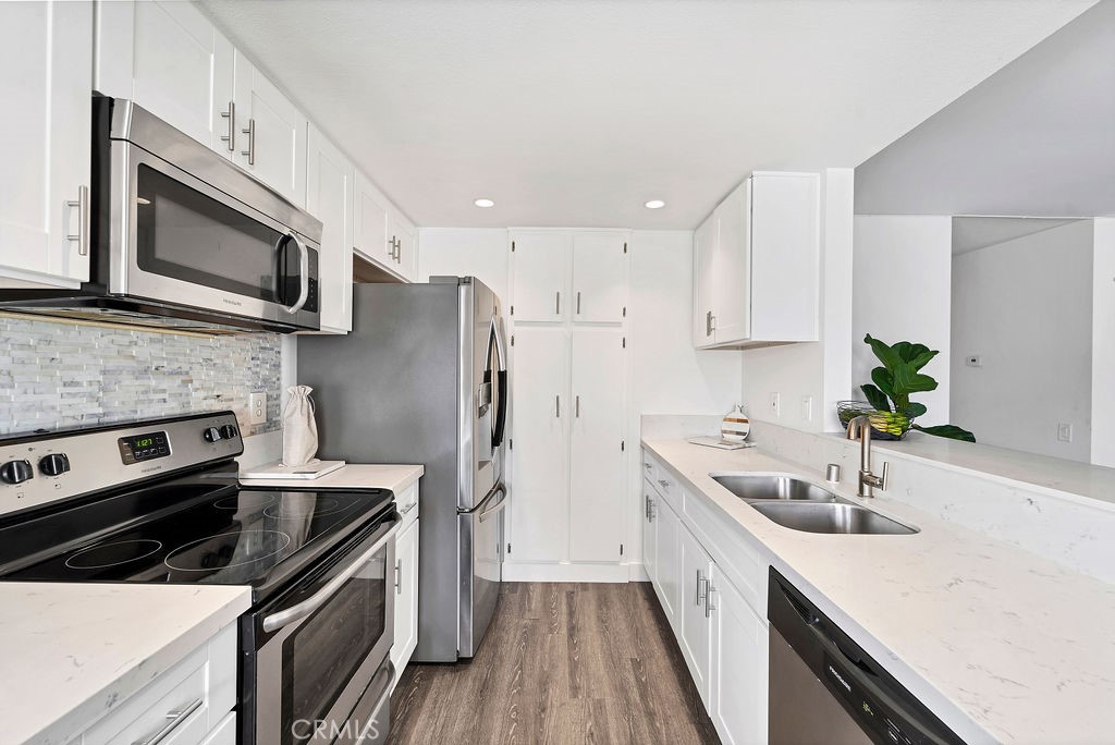 4267 Arcata Bay Way Oceanside, CA 92058 - Photo 25 of 34 a kitchen with stainless steel appliances a stove microwave and sink