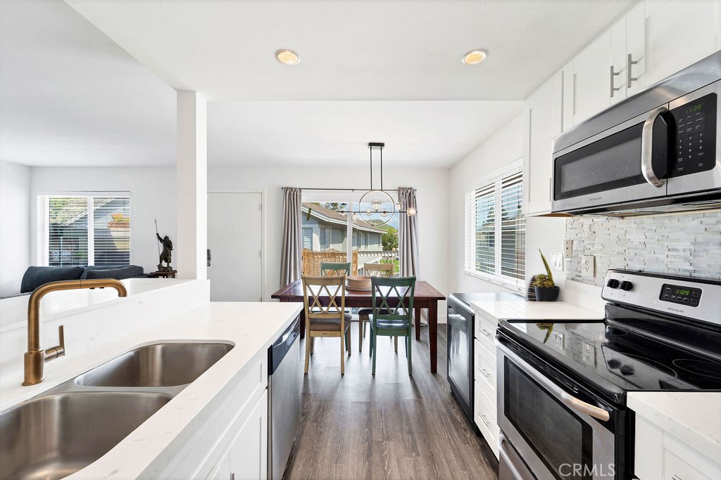 4267 Arcata Bay Way Oceanside, CA 92058 - Photo 29 of 34 a kitchen with a stove sink and microwave