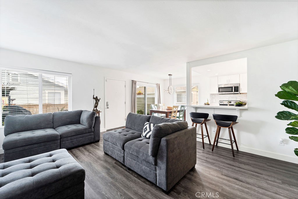 4267 Arcata Bay Way Oceanside, CA 92058 - Photo 6 of 34 a living room with furniture wooden floor and a window