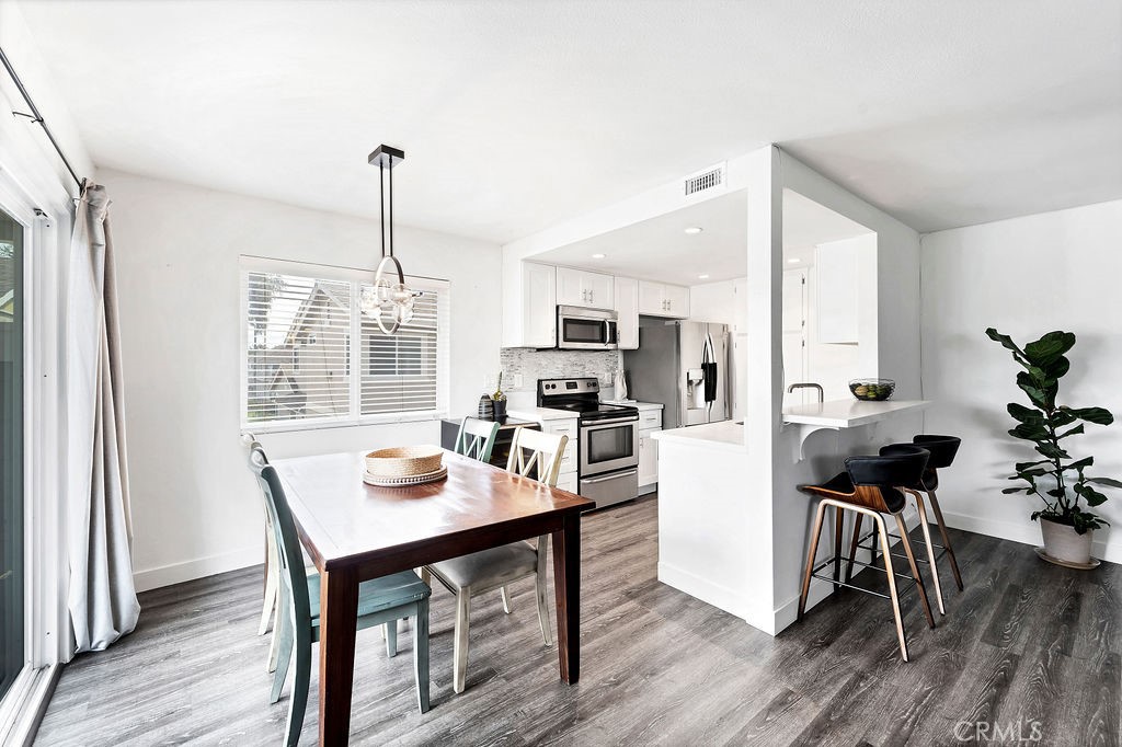 4267 Arcata Bay Way Oceanside, CA 92058 - Photo 7 of 34 a kitchen with a dining table and chairs