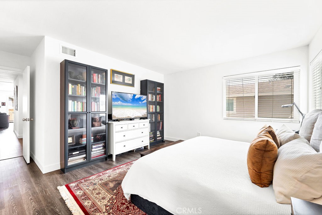 4267 Arcata Bay Way Oceanside, CA 92058 - Photo 8 of 34 a bedroom with a bed and wooden floor