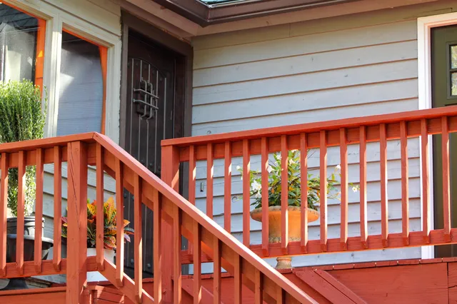 a living room with furniture a rug potted plant and a large window