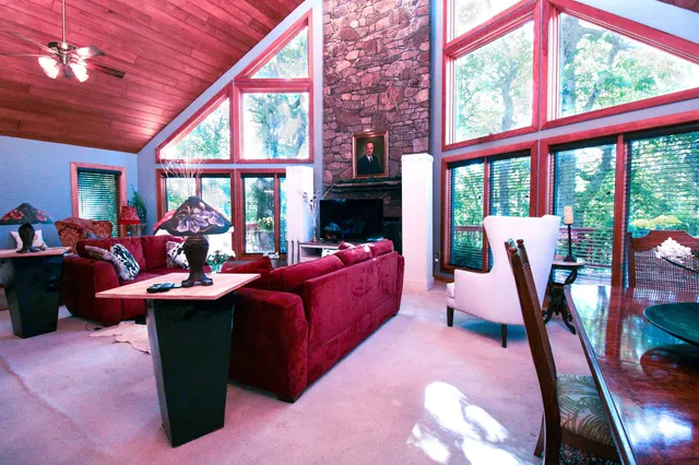 a living room with furniture and a floor to ceiling window