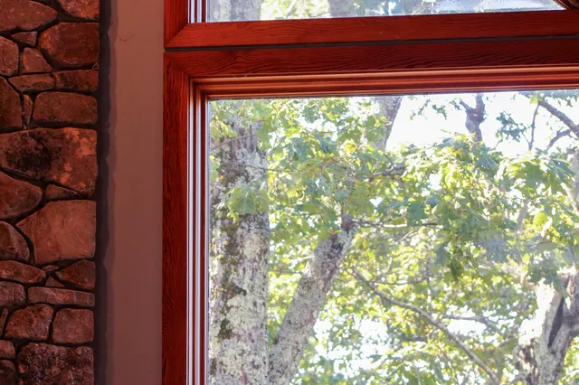 a balcony with wooden floor and trees