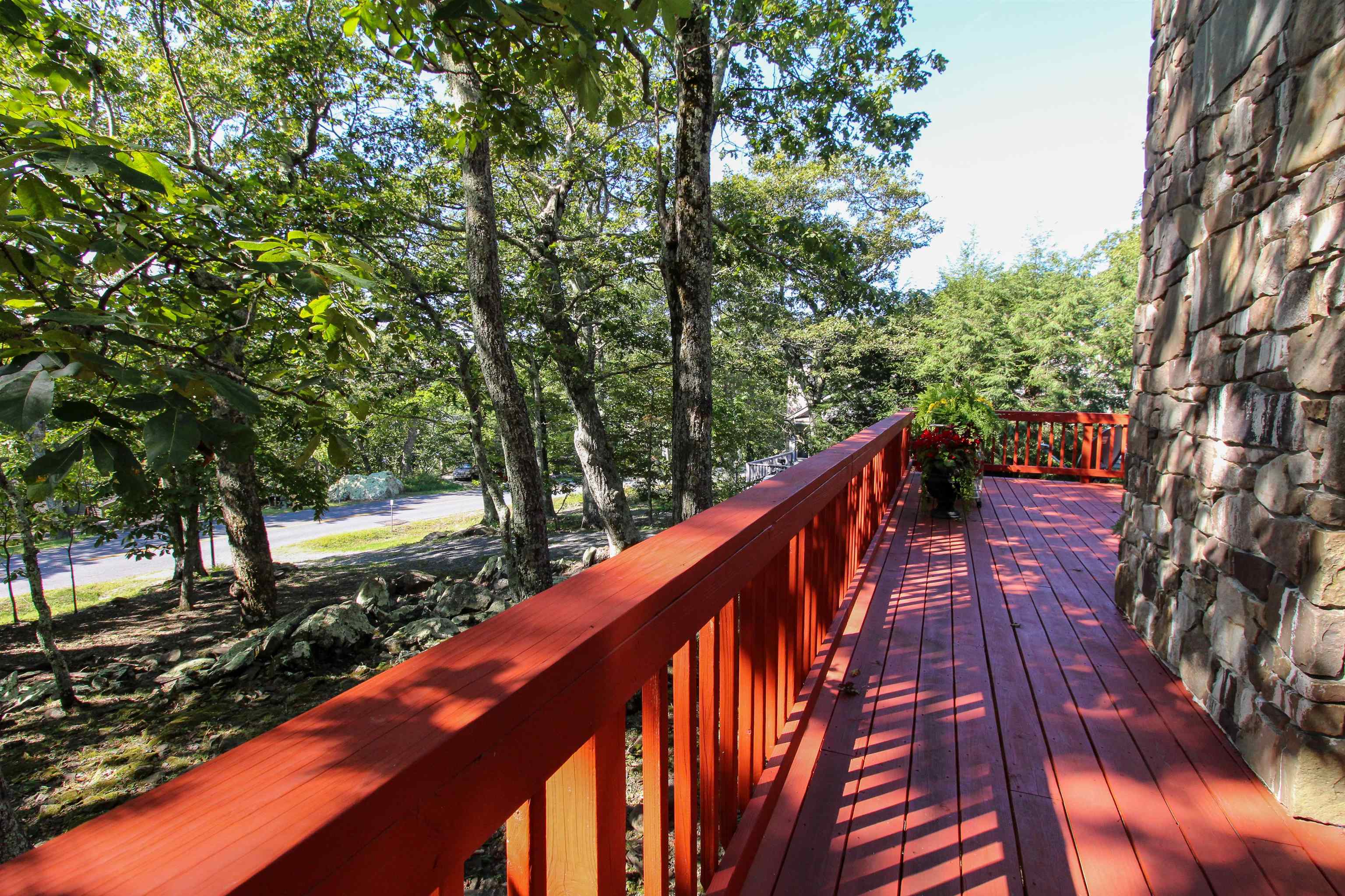781 Devils Knob Loop Roseland, VA 22967 - Photo 41 of 68 a balcony with wooden floor and trees