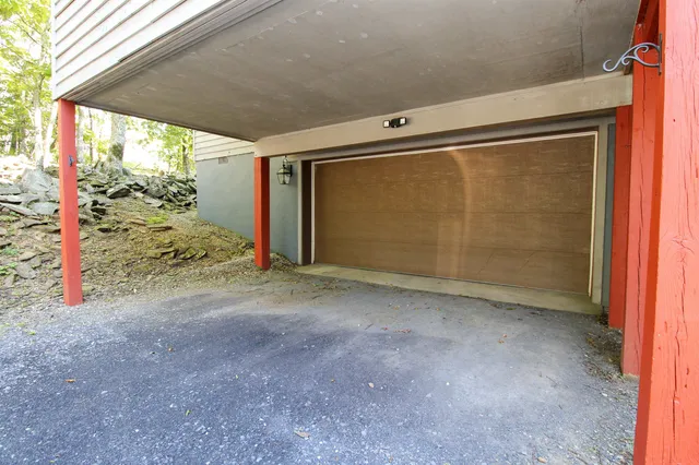 a view of a house with a tree and a yard in front of it