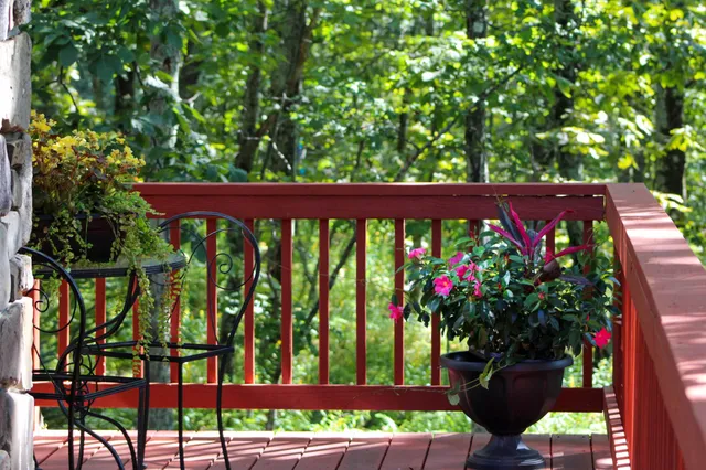 a view of a chairs and table in the balcony