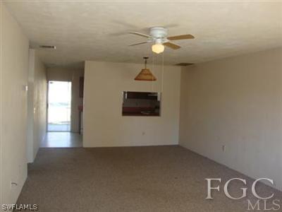 7425 Pebble Beach Road Fort Myers, FL 33967 - Photo 3 of 9 en empty room with windows and fan