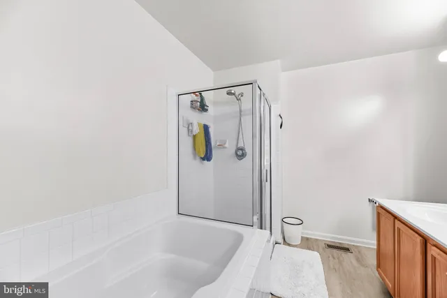 a bathroom with a tub and shower