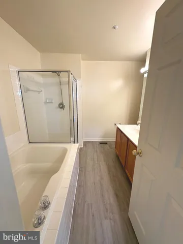 a view of a house with a small yard and wooden fence