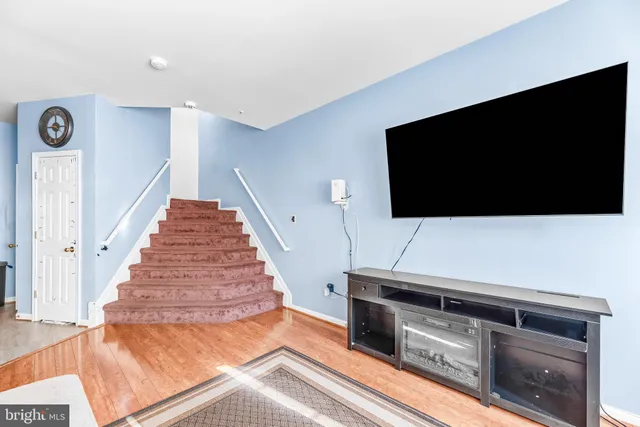 a living room with a flat screen tv and a fireplace