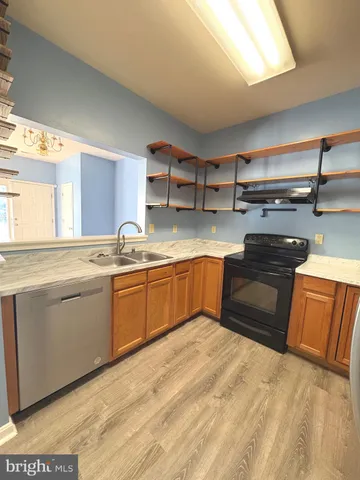 a kitchen with a sink stove and cabinets