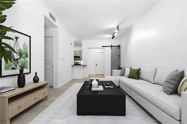 a living room with furniture ceiling fan and a window