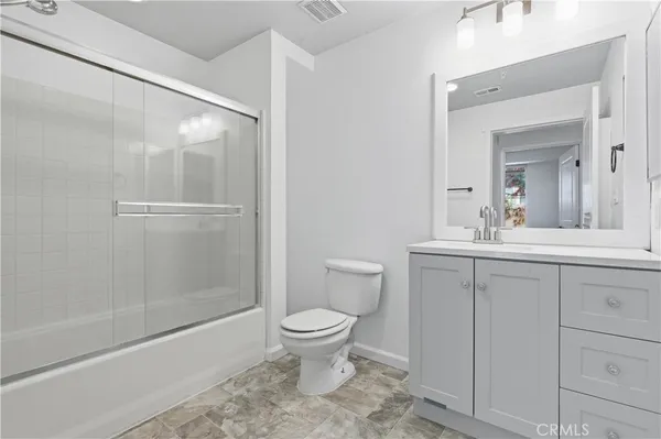 a bathroom with a shower and a toilet