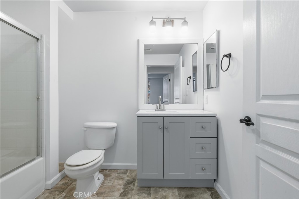 2311 Watermarke Place Irvine, CA 92612 - Photo 22 of 33 a bathroom with a toilet sink and mirror