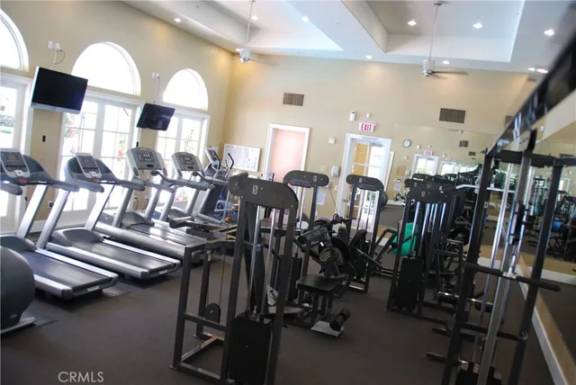 a living room with furniture pool table and flat screen tv
