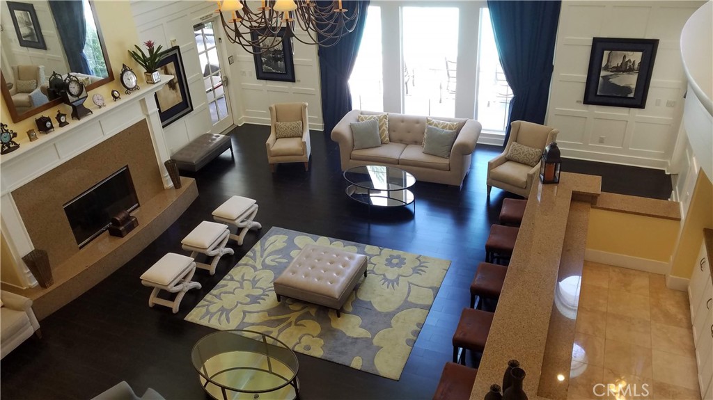 2311 Watermarke Place Irvine, CA 92612 - Photo 25 of 33 a living room with furniture fireplace and a flat screen tv