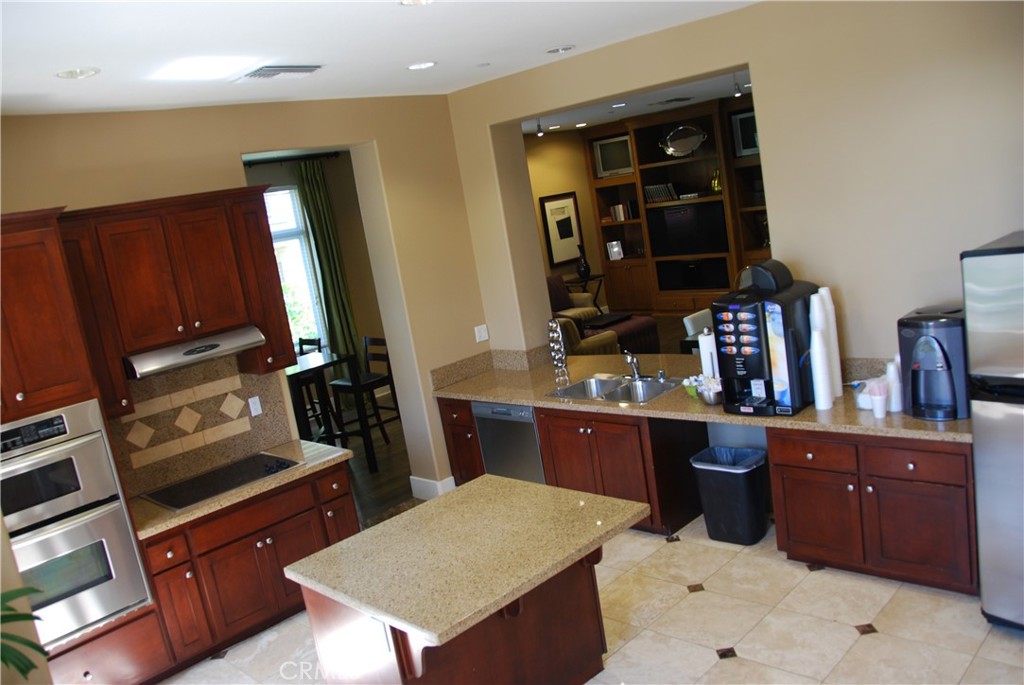 2311 Watermarke Place Irvine, CA 92612 - Photo 29 of 33 a kitchen with a sink and cabinets