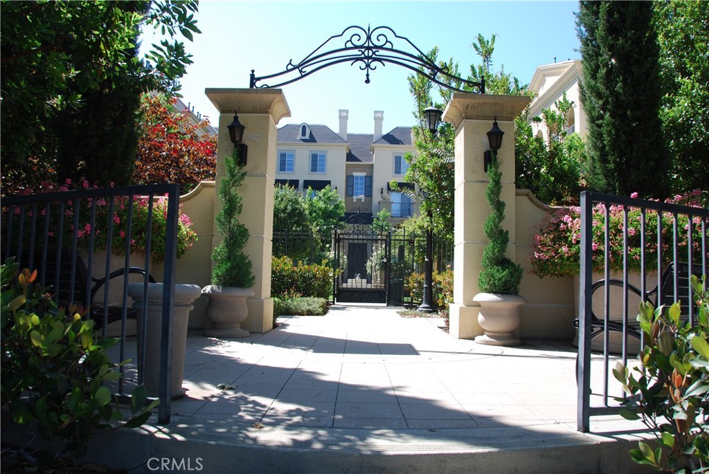 2311 Watermarke Place Irvine, CA 92612 - Photo 30 of 33 a front view of a house with a garden
