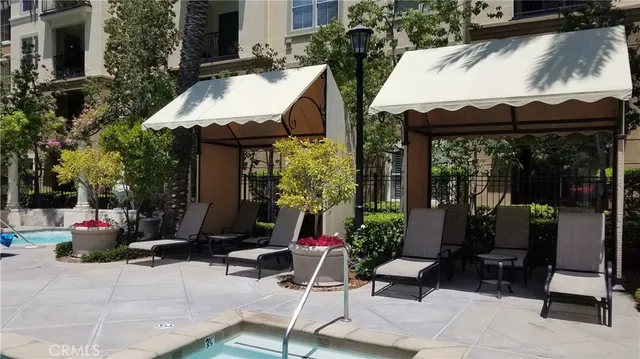 a view of a house with swimming pool and sitting area