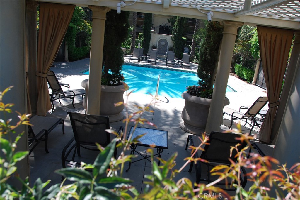 2311 Watermarke Place Irvine, CA 92612 - Photo 33 of 33 a view of a patio with table and chairs potted plants with wooden floor