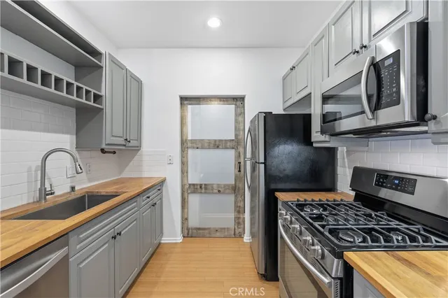a kitchen with a refrigerator and a sink