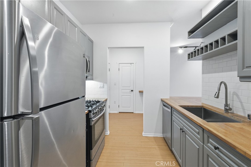 2311 Watermarke Place Irvine, CA 92612 - Photo 10 of 33 a kitchen with a refrigerator and a sink