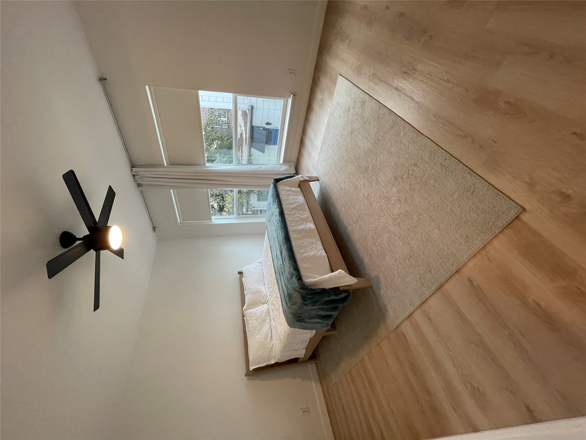 1714 Enfield Road, Unit 102 Austin, TX 78703 - Photo 7 of 15 Natural light fills this bedroom featuring hard surface flooring and a contemporary ceiling fan.
