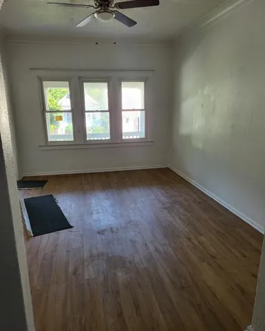 wooden floor in an empty room with a window