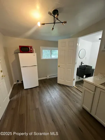 a view of hallway with wooden floor