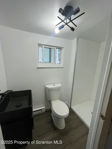 a bathroom with a toilet a sink and a mirror