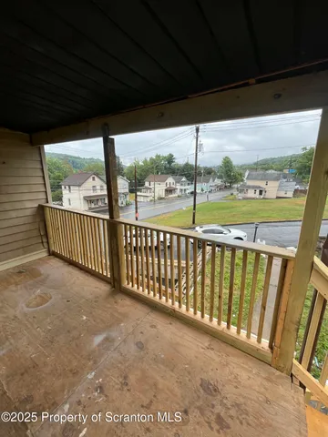 a view of a roof deck with wooden floor and fence