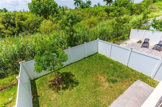 a view of a house with a backyard and a garden