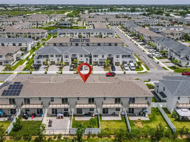 an aerial view of a house with a swimming pool yard and outdoor seating