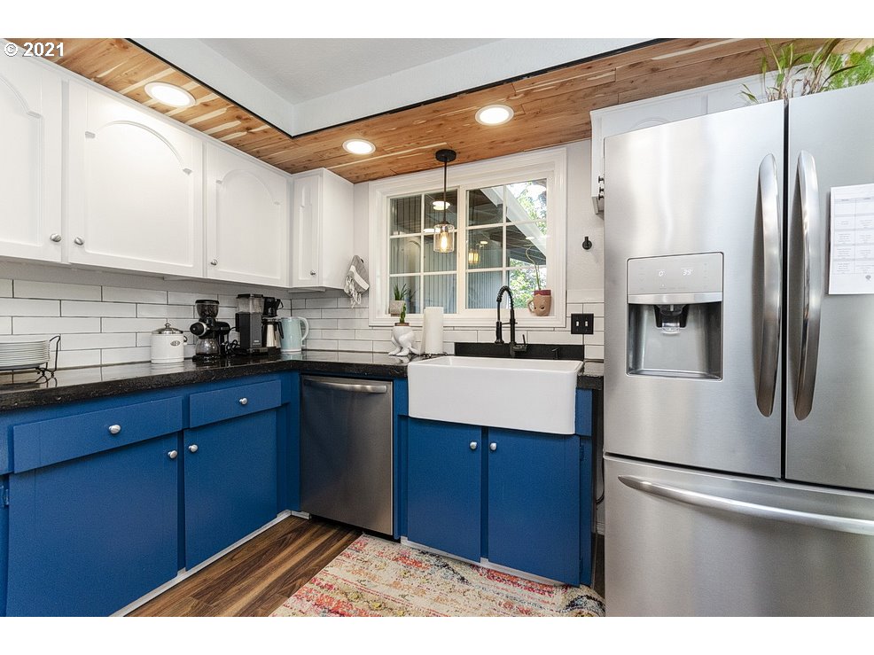 290 Southeast Palmblad Drive Gresham, OR 97080 - Photo 12 of 32 a kitchen with stainless steel appliances granite countertop a refrigerator a sink a stove and white cabinets