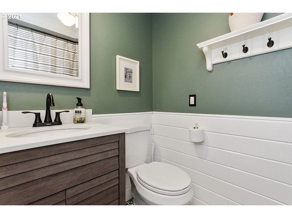 290 Southeast Palmblad Drive Gresham, OR 97080 - Photo 15 of 32 a bathroom with a sink a toilet and mirror