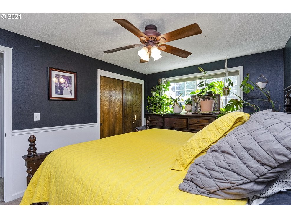 290 Southeast Palmblad Drive Gresham, OR 97080 - Photo 21 of 32 a bed room with a bed and a large window