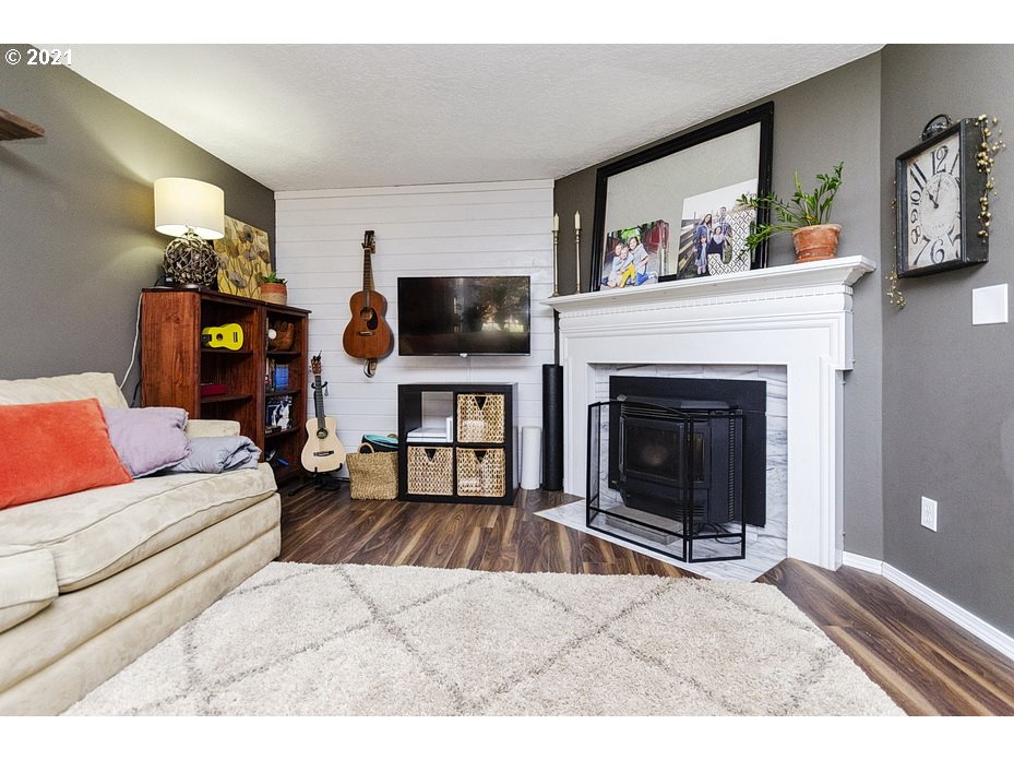 290 Southeast Palmblad Drive Gresham, OR 97080 - Photo 6 of 32 a living room with furniture and a fireplace
