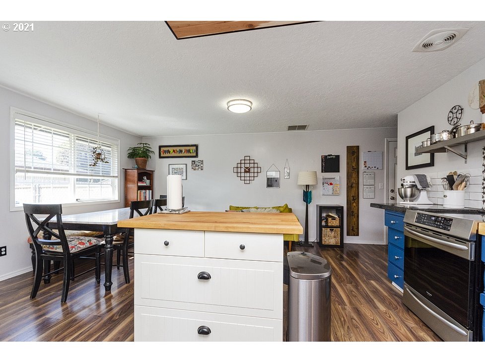 290 Southeast Palmblad Drive Gresham, OR 97080 - Photo 8 of 32 a kitchen with stainless steel appliances granite countertop a stove and a refrigerator
