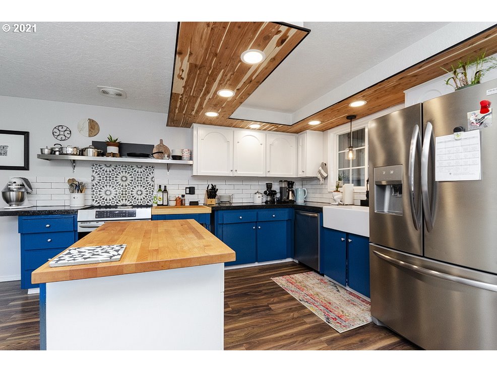 290 Southeast Palmblad Drive Gresham, OR 97080 - Photo 10 of 32 a kitchen with stainless steel appliances granite countertop a refrigerator a sink dishwasher a stove with white cabinets