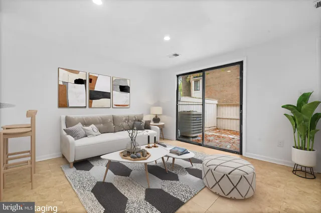 a living room with furniture and a potted plant