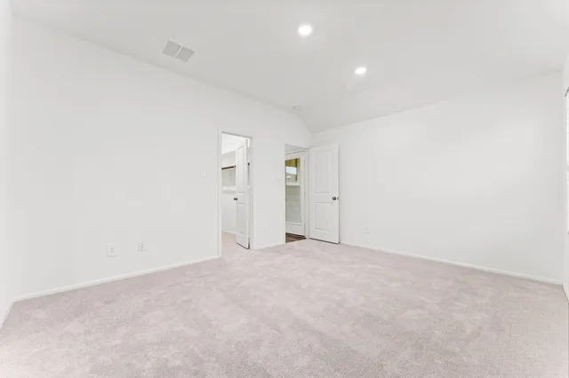 a large kitchen with stainless steel appliances kitchen island a stove a refrigerator a sink and a oven with wooden floor