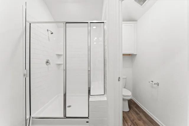 an empty room with windows and closet