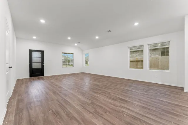 a view of empty room with a fireplace