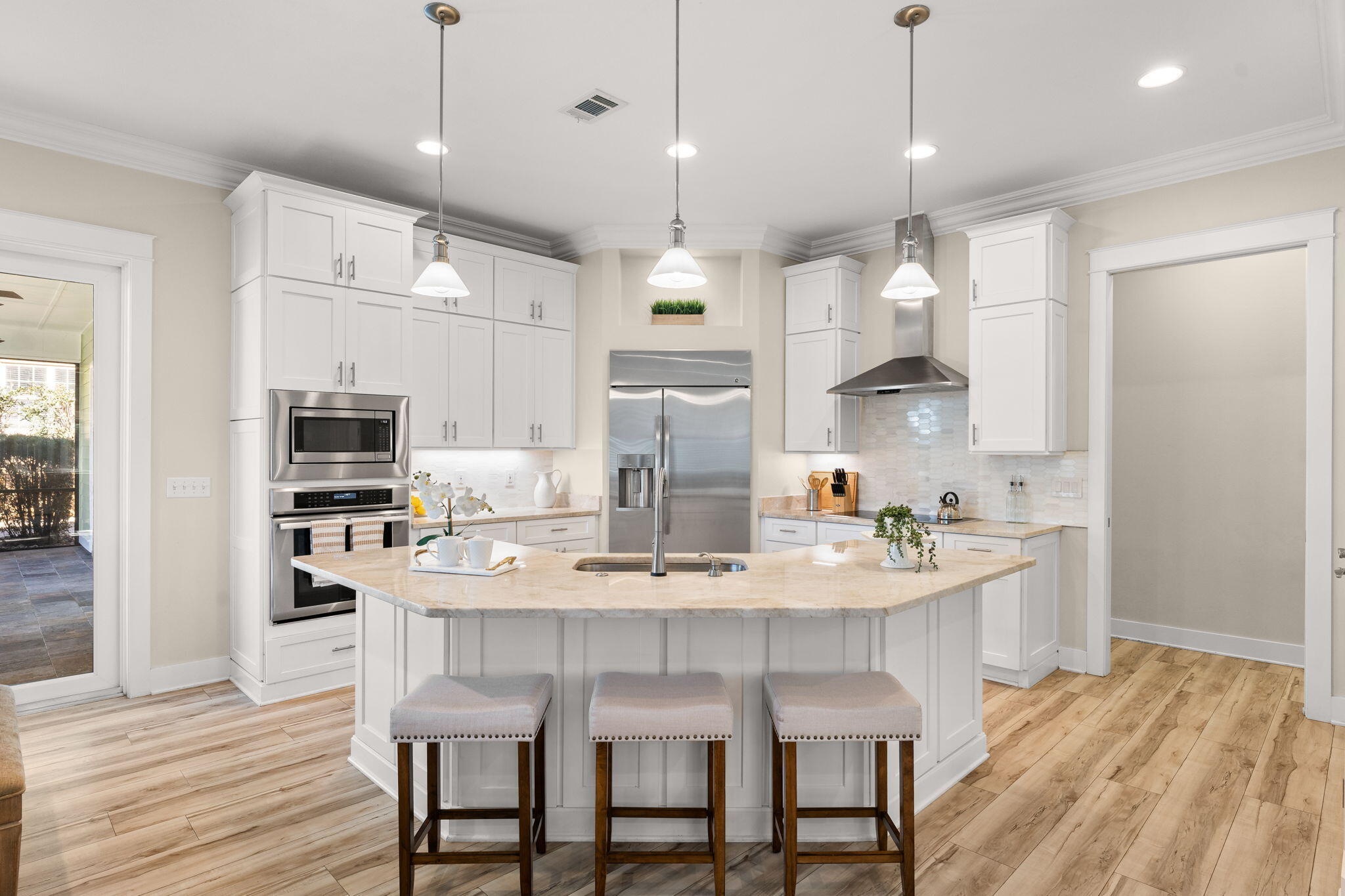 81 Botany Boulevard Santa Rosa Beach, FL 32459 - Photo 12 of 62 a kitchen with granite countertop a table chairs stainless steel appliances and cabinets