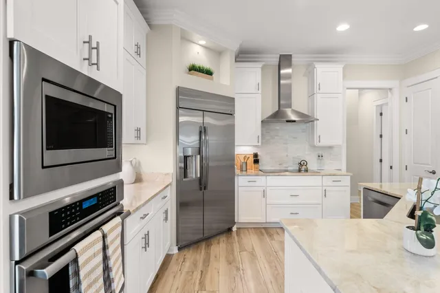 a large kitchen with a table and chairs