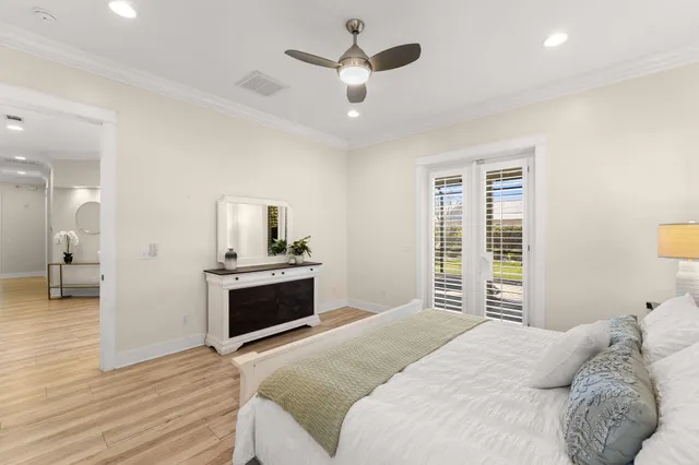 a spacious bathroom with a double vanity sink a large mirror a bathtub and next to a window