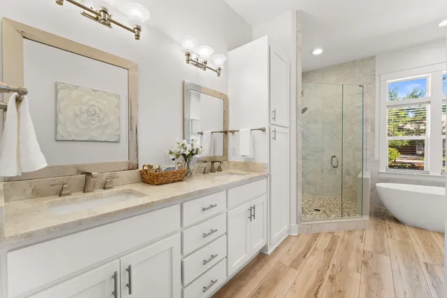 a bathroom with a granite countertop sink a toilet and shower